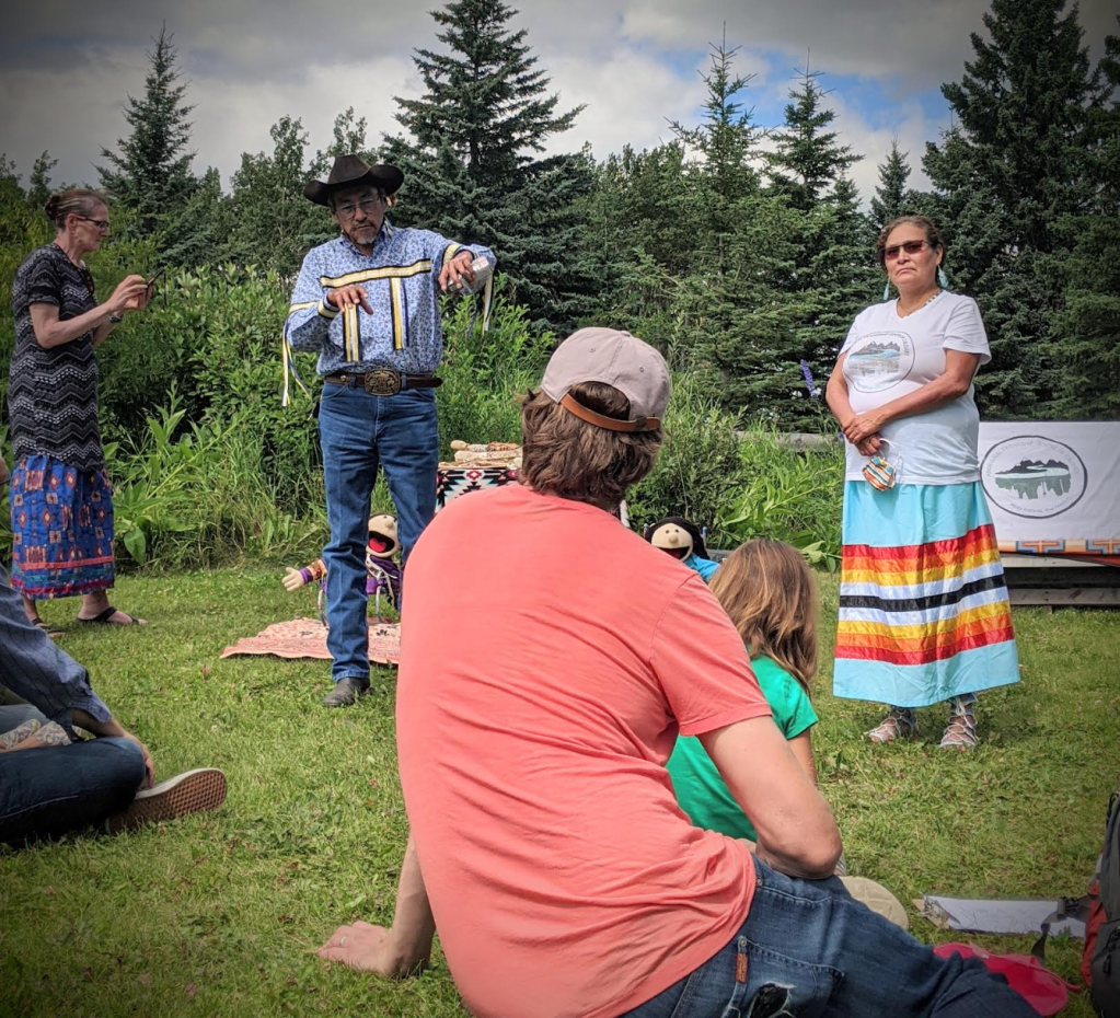 a group of people listening to an elder tell a story
