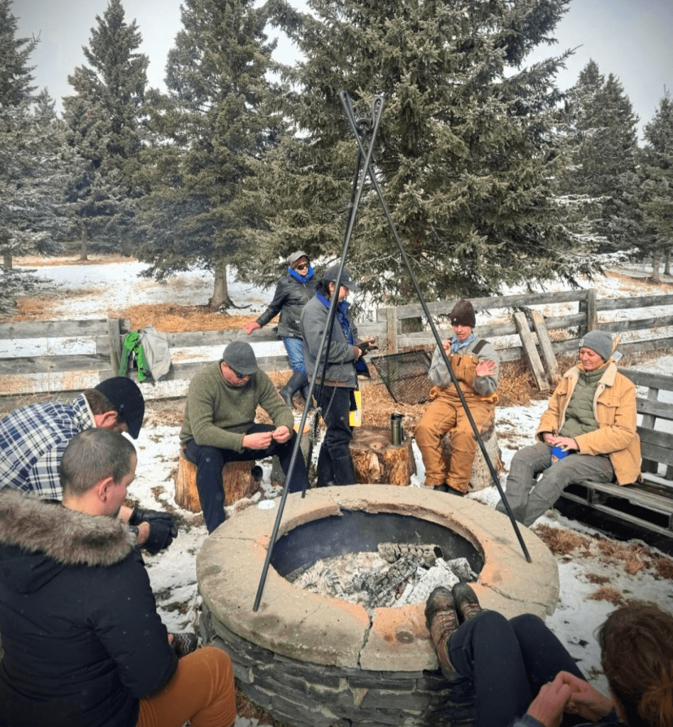 People gathered around a fire, talking